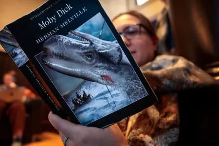 A guest follows along during the 25-hour-long reading of Herman Melville's Moby-Dick; or, the Whale at the New Bedford Whaling Museum in Massachusetts.&nbsp;