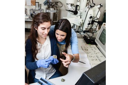 Smithsonian geologist Elizabeth Cottrell (right) helps undergraduate intern Kellie Wall examine a sample of Earth’s interior. Cottrell co-directs Natural History Research Experiences, a program funded by the National Science Foundation that trains 18 students every summer.