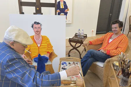 David Hockney paints the portrait of Harry Styles that is currently on display in the exhibition.