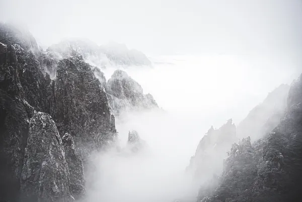 This photo was shot on a snowy day on the Huang Mountain near Anhui province. It was a very foggy day, and the mountain was showing off with lots white. It looked very much like a Chinese painting.