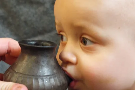 Modern-day baby feeding from reconstructed infant feeding vessel of the type investigated in the new study. 