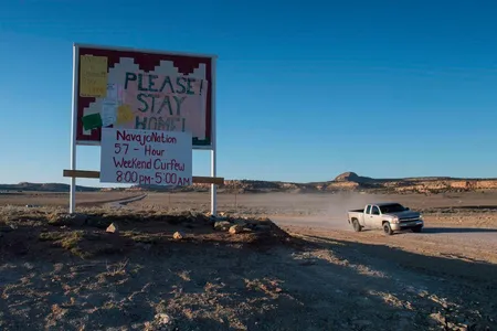 A sign asks Navajo residents to stay safe and warns of a curfew near the Navajo Nation town of Casamero Lake in New Mexico on May 20, 2020.