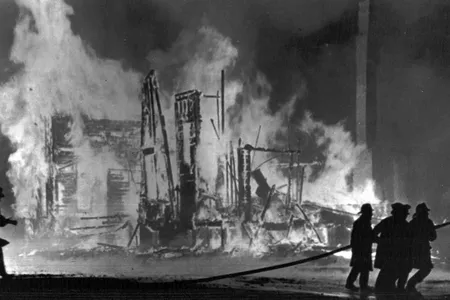 Firemen fight to control blazing buildings in Detroit on July 25, 1967. The city was filled with gunfire, looting and police officers for five days that July.