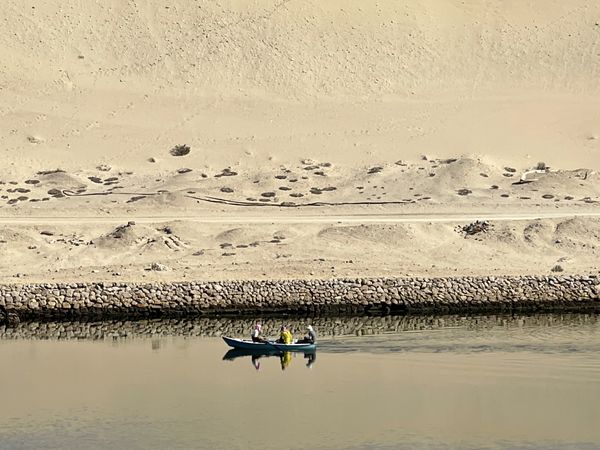 Men on small boat in Suez Canal thumbnail