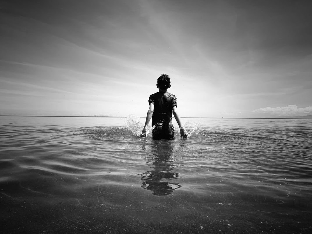 Silhouette of a child in the water