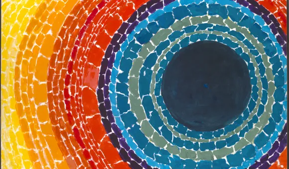 Painting with a dark blue center circle surrounded by concentric circles of reds, oranges, and yellow