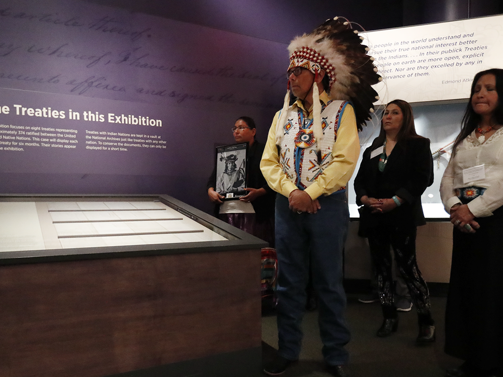 Ramey Growing Thunder (Fort Peck Sioux and Assiniboine Tribes), Chief John Spotted Tail (Rosebud Sioux Tribe), Carolyn Brugh (Fort Peck Sioux and Assiniboine Tribes), and Tamara Stands and Looks Back–Spotted Tail (Rosebud Sioux Tribe) take part in a ceremony at the National Museum of the American Indian honoring the Treaty of Fort Laramie. Ms. Growing Thunder holds a photograph of Medicine Bear (Yanktonai Band of Sioux), one of the Native leaders who signed the treaty 150 years ago. Delegations from the Yankton Sioux Tribe, Oglala Sioux Tribe, and Northern Arapaho Tribe also traveled to Washington, D.C., for the installation of the treaty in the exhibition 