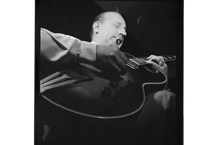 Carl Kress, performer of "Heat Wave" on Volume I, focuses absolutely on his guitar-playing.