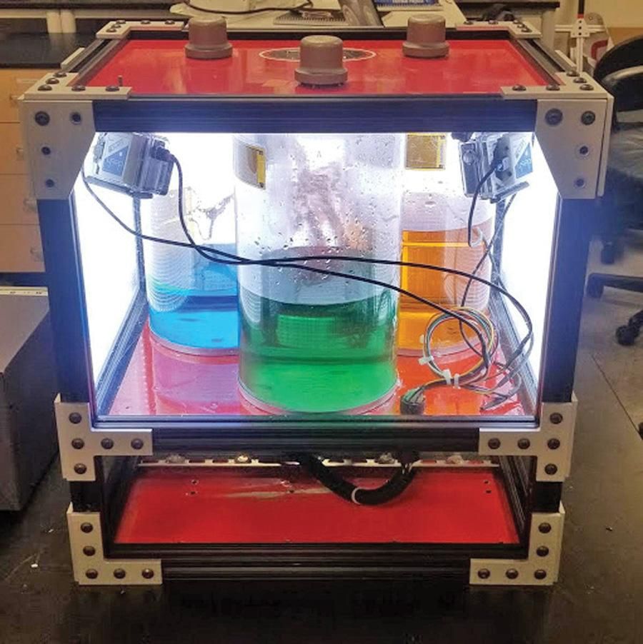 box with multicolored water inside glass containers with sensors attached