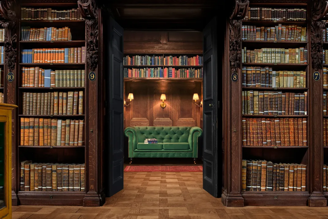 Green couch and shelves of books