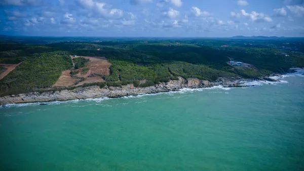 Aerial view of a shoreline, valleys and hills in Central region of Ghana, West Africa thumbnail