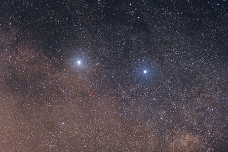 The Centauri system: Alpha Centauri A is the bright star to the left, Alpha Centauri B is the bright star to the right, and Proxima Centauri is circled in red.