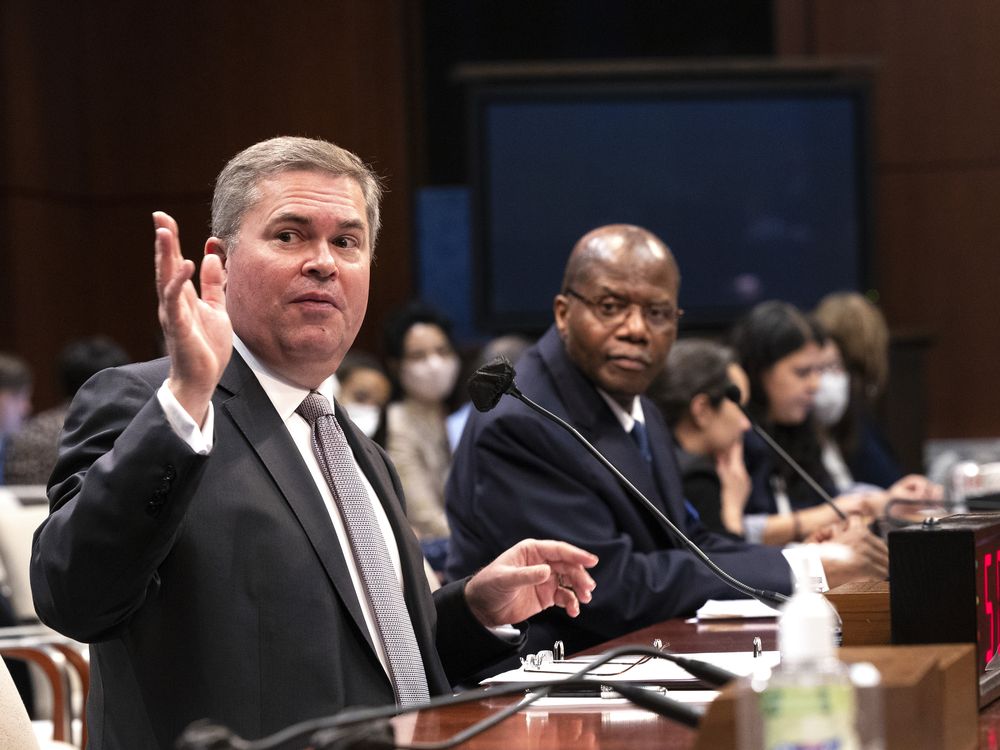 two men seated at a congressional hearing