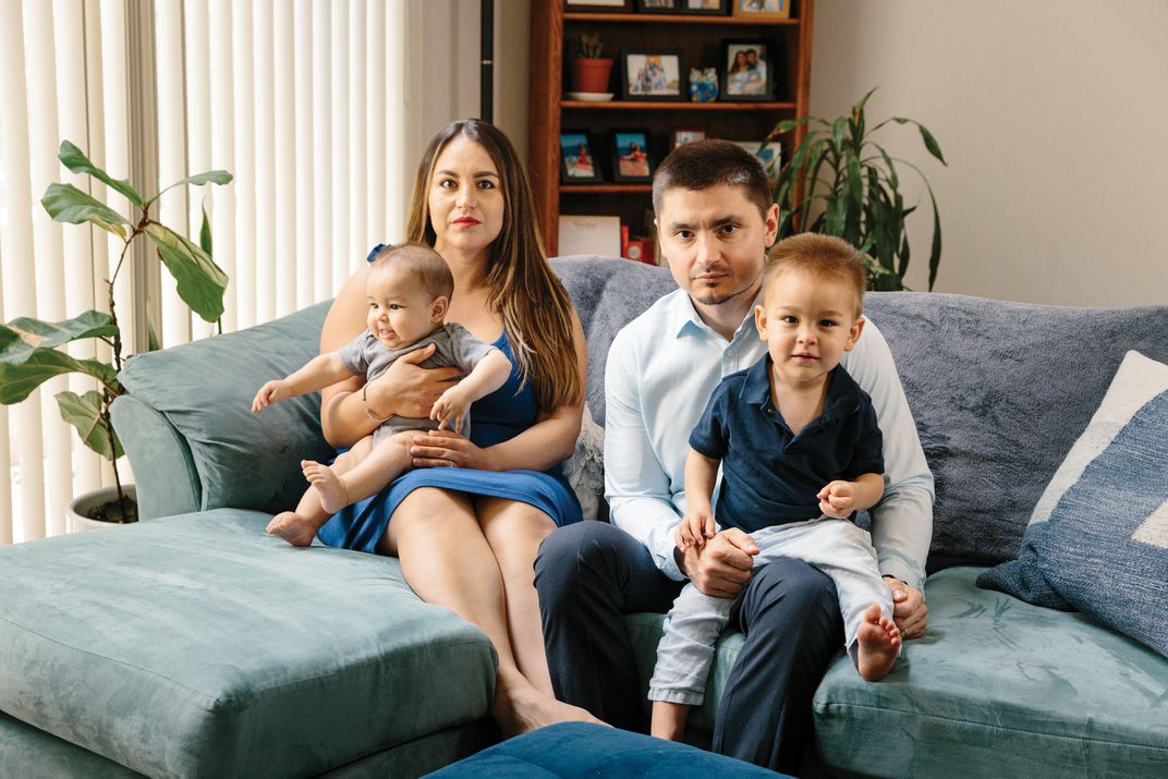 a family sits on a sofa for a portrait