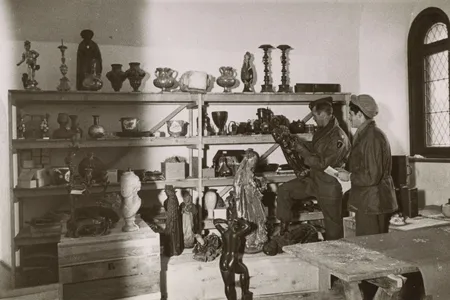 American soldiers sift through art looted by the Nazis at Neuschwanstein Castle in 1945