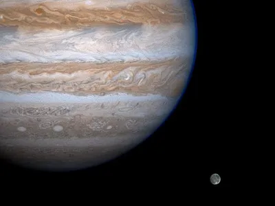 An enhanced-contrast image of Jupiter and its moon Ganymede taken by NASA&#39;s Cassini spacecraft in 2000.