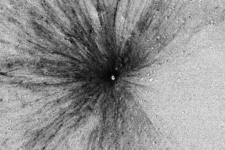 A before-and-after composite shows the lunar surface with a surprising starburst-like jet pattern.