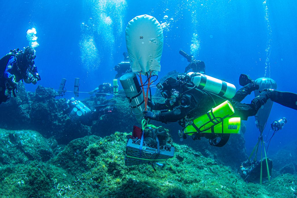 Divers at the Antikythera shipwreck bring up the massive head of Hercules.
