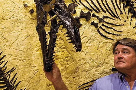 Fossil prospector Ron Frithiof (with a mosasaur from his collections) was sued over a T. rex that he uncovered.  "This whole experience," he says, "has been a disaster."