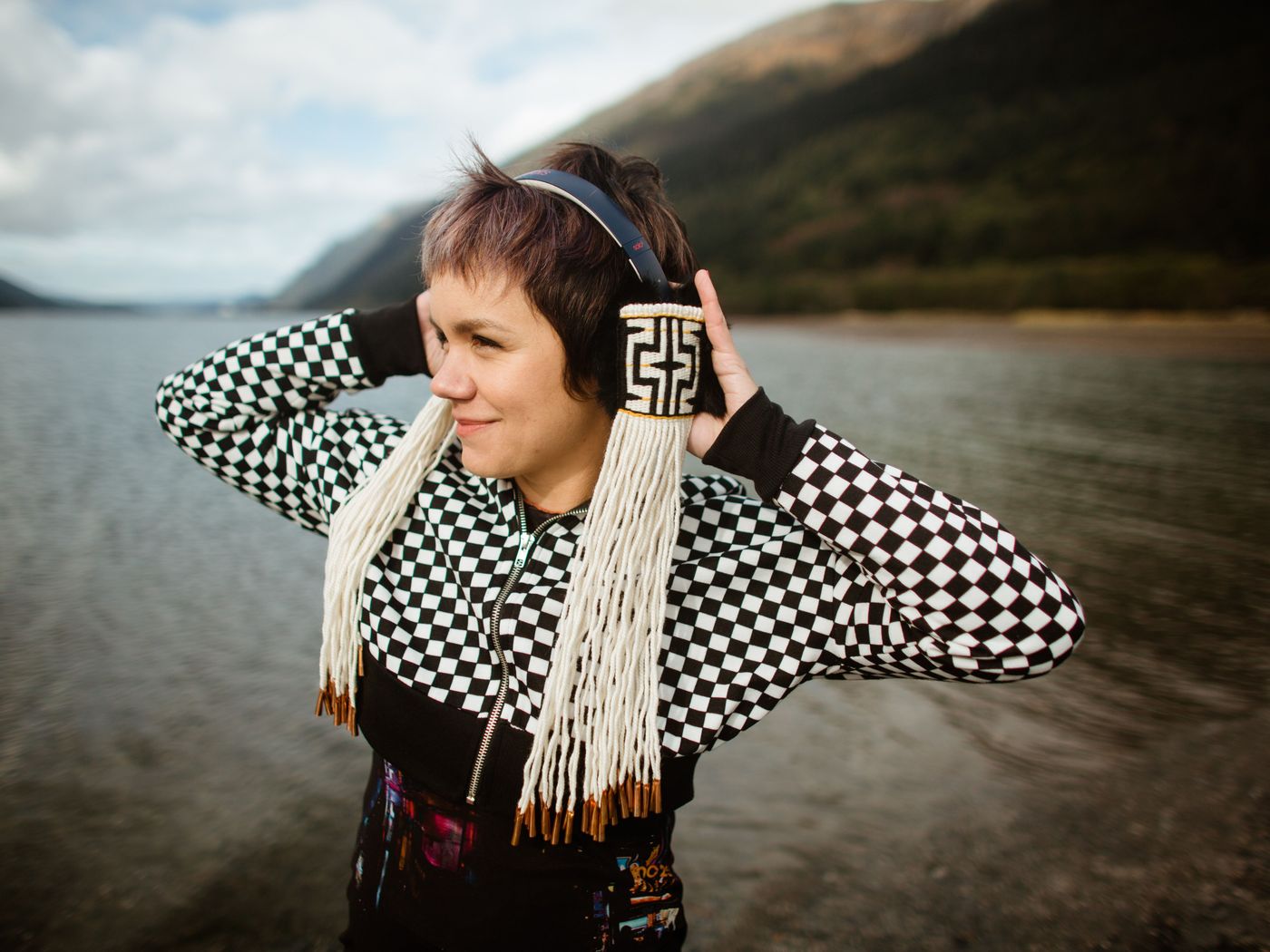 a model wears woven headphones with long tassels