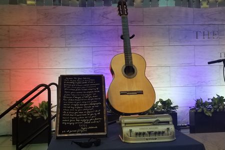 Clockwise from upper right, the items Feliciano donated to the Smithsonian included: his beloved Concerto Candelas guitar, a Braille writer his wife Susan used, a pair of his trademark glasses, and a heartfelt embroidered note from a Japanese admirer.