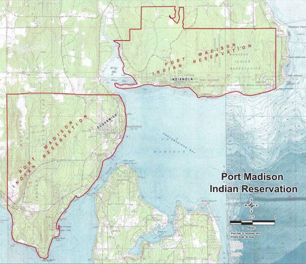 Map showing a portion of the Puget Sound and surrounding land masses. Two areas of land are outlined in red, marked Port Madison Indian Reservation.
