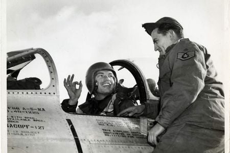 Lt. Ward Hitt, Jr., sitting in the cockpit of his North American F-86A Sabre fighter, gives his crew chief the OK hand sign, South Korea.
