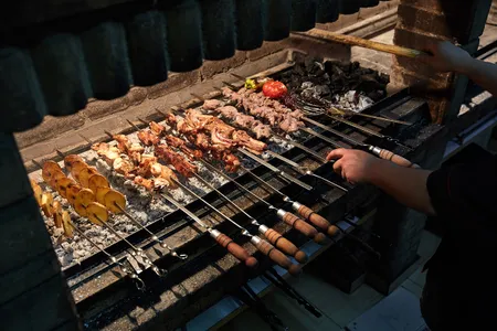 A cook works on khorovats skewers at Taron Restaurant in Yerevan.