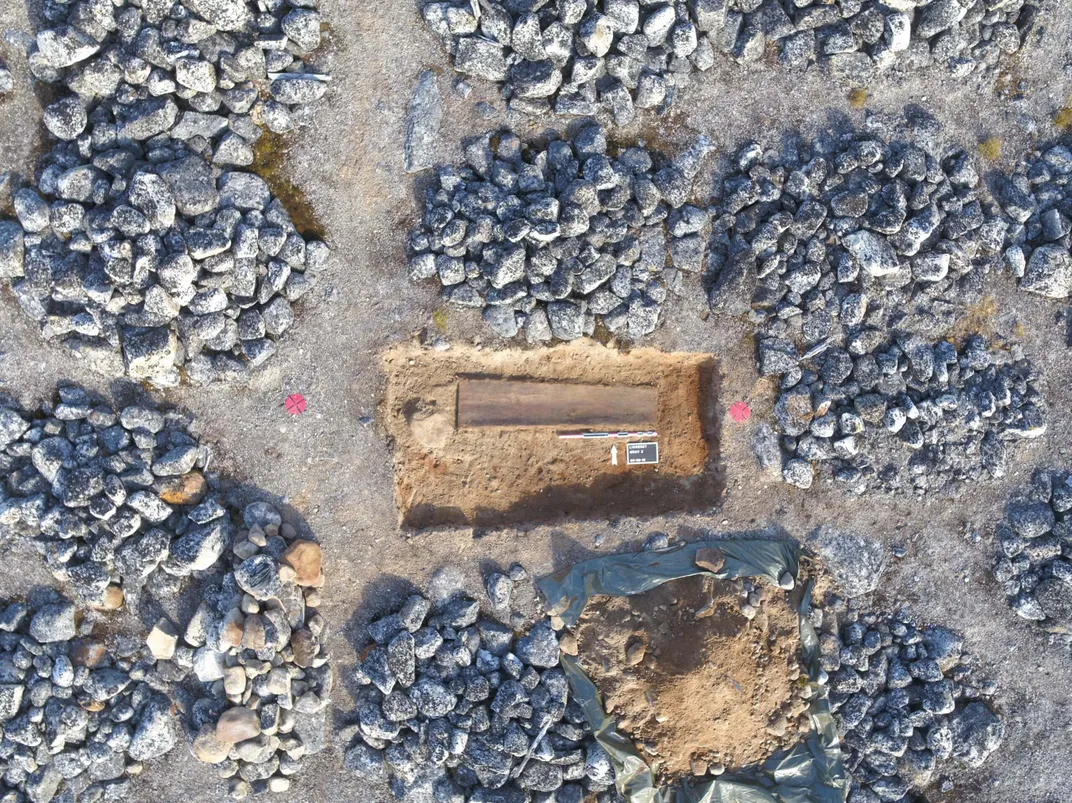 An overhead view of a grave being excavated