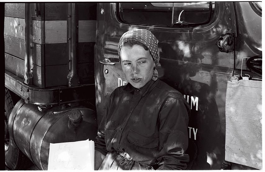 a women sits against a truck