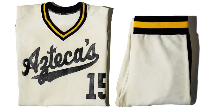 White jersey with green and yellow trim reading "Aztecas"