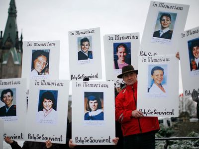 Demonstrators hold portraits of some of the victims of the Montréal Massacre during the National Day of Remembrance and Action on Violence Against Women rally on Parliament Hill in Ottawa December 6, 2011.