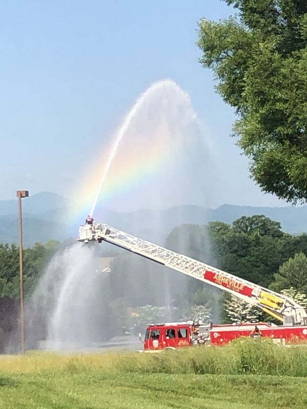 Firefighter with rainbow and mountain backdrop thumbnail