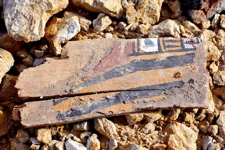 A painted wooden coffin beside a looted tomb in the Abu Sir al Malaq necropolis in Bani Suef, Egypt.
