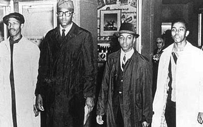 Ezell A. Blair, Jr. (now Jibreel Khazan), Franklin E. McCain, Joseph A. McNeil, and David L. Richmond leave the Woolworth store after the first sit-in on February 1, 1960.