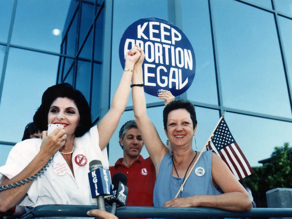 Attorney Gloria Allred (left) and Norma McCorvey (right), the anonymous plaintiff in Roe v. Wade, during a pro-choice rally in Burbank, California, on July 4, 1989
