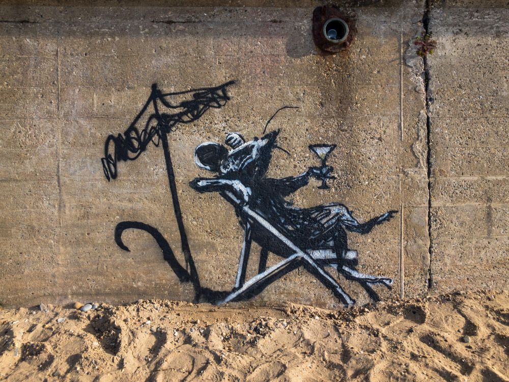 Banksy mural of a rat sipping a cocktail