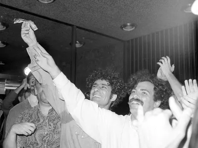 Political activists Abbie Hoffman, left, and Jerry Rubin set five-dollar bills on fire at the Financial Center in New York on August 24, 1967.