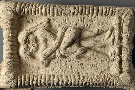 A Babylonian clay model dated to 1800 B.C.E. shows a nude couple on a couch engaged in sex and kissing.