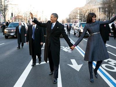Barack and Michelle Obama walk down Pennsylvania Avenue together on Inauguration day, 2013.