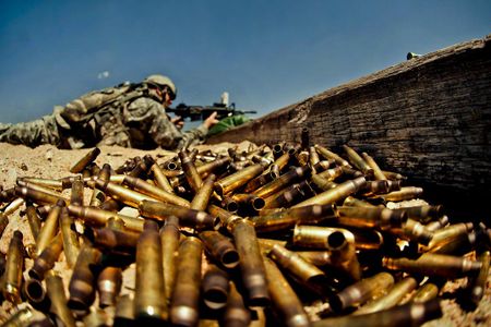 Spent shell casings pile up as a soldier fires his weapon during a U.S. Army weapons qualification.