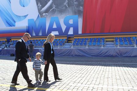 Doug Hurley, Karen Nyberg, and son Jack walk in Red Square a few weeks before her launch to the space station in May 2013.
