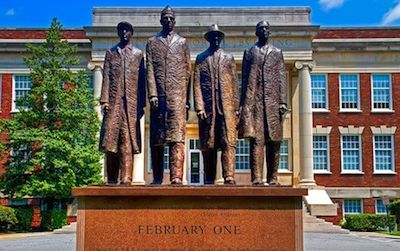 The “Greensboro Four,” above immortalized on their North Carolina A&T State University campus, fought racial segregation by refusing to leave a local retail store when the staff would not serve them coffee. Learn to protest like a pro this weekend at the American History Museum.