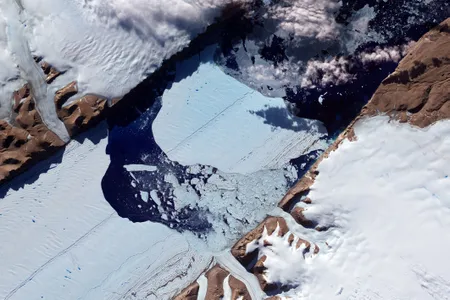 A massive ice island breaks free of the Petermann Glacier in northwestern Greenland in July 2012.