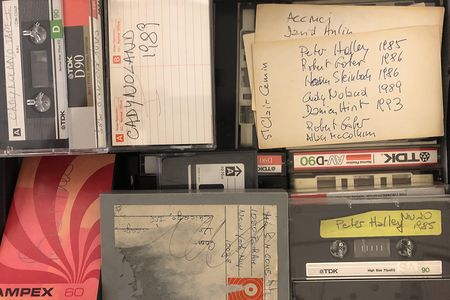 Color image of various audio recordings, some with handwritten labels.