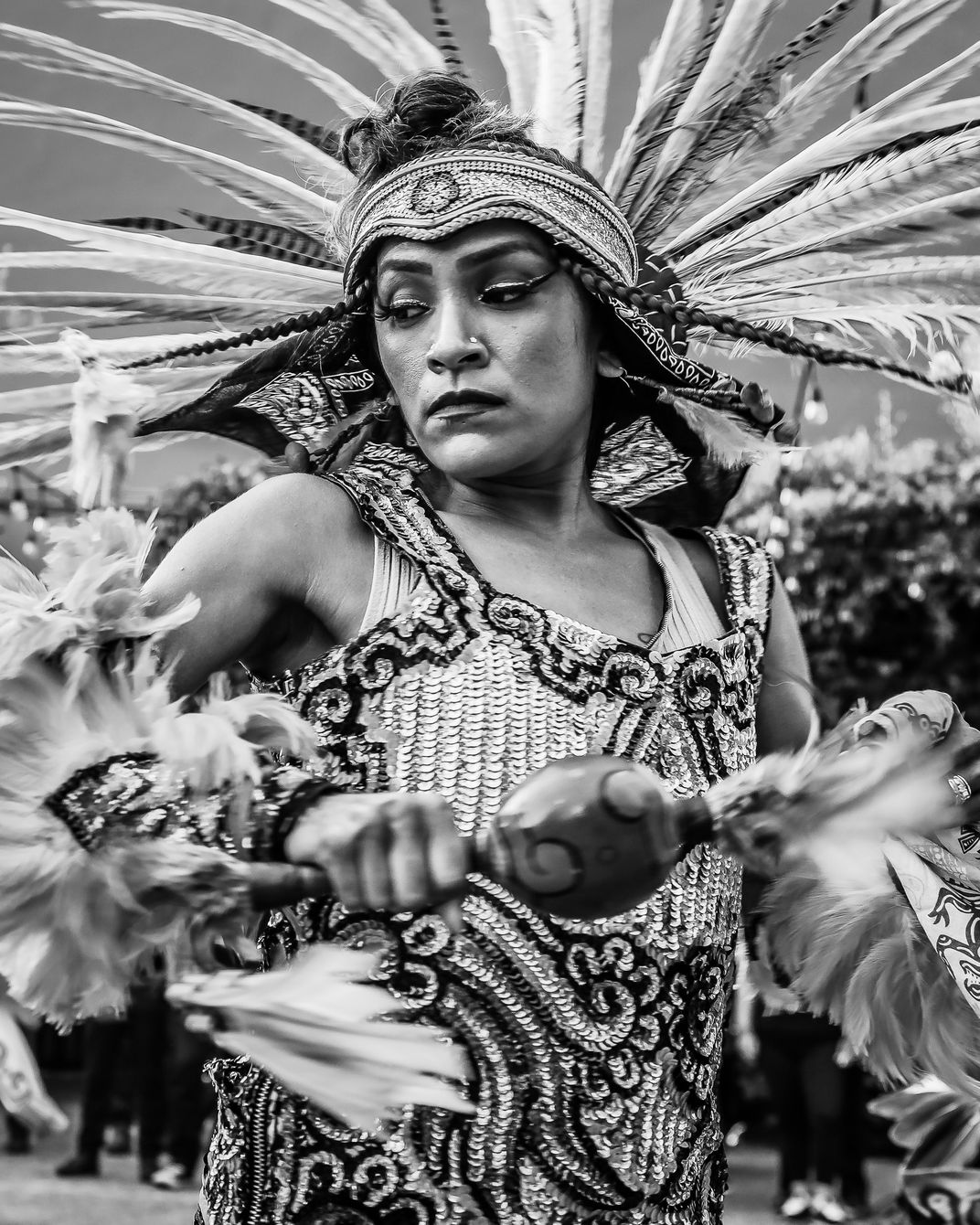 A black and white image of a Aztec woman dancing