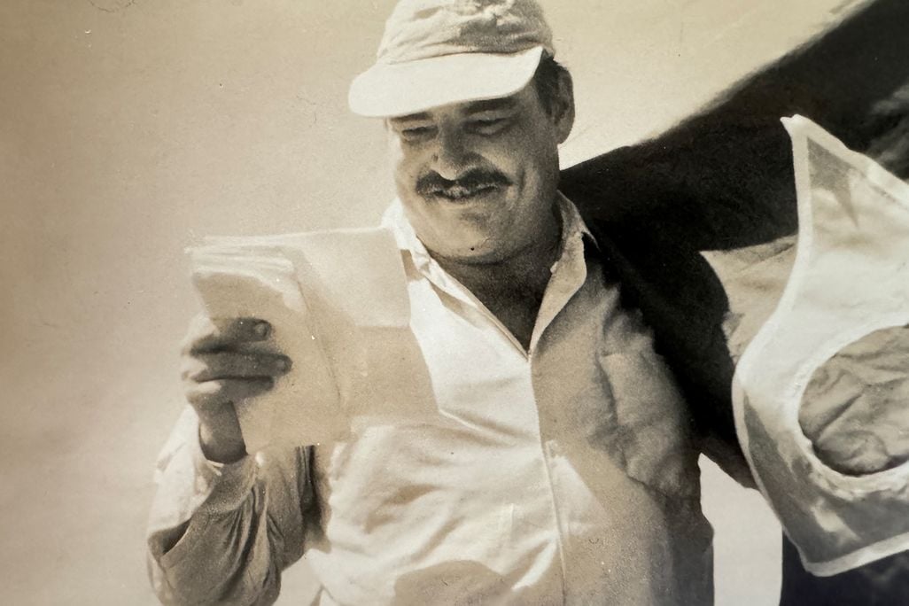 Leicester Hemingway reading a piece of paper