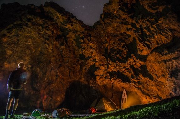 The tent is pitched against a cliff, and the stars of the Baja sky come out.