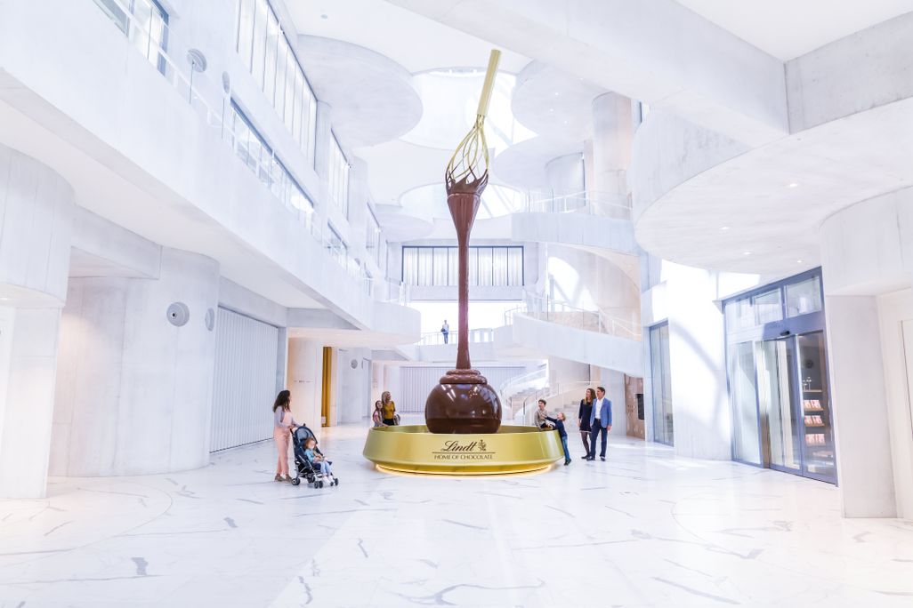 The entrance to the Lindt Home of Chocolate includes a 30-foot chocolate fountain topped with a giant golden whisk 