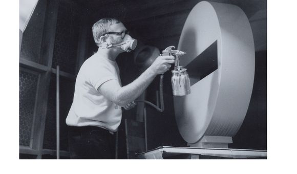 Photograph of Tony DeLap spray painting sculpture in Costa Mesa studio (detail), 1970 March / unidentified photographer. Tony DeLap papers, circa 1950-2015. Archives of American Art, Smithsonian Institution.